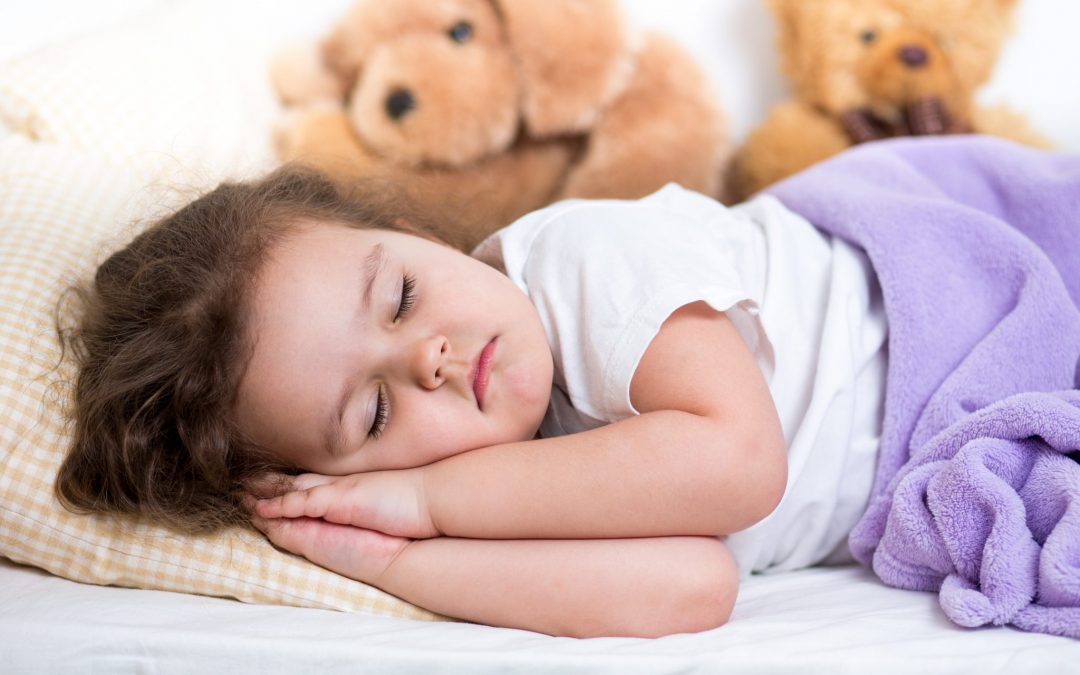 child sleeping on mattress
